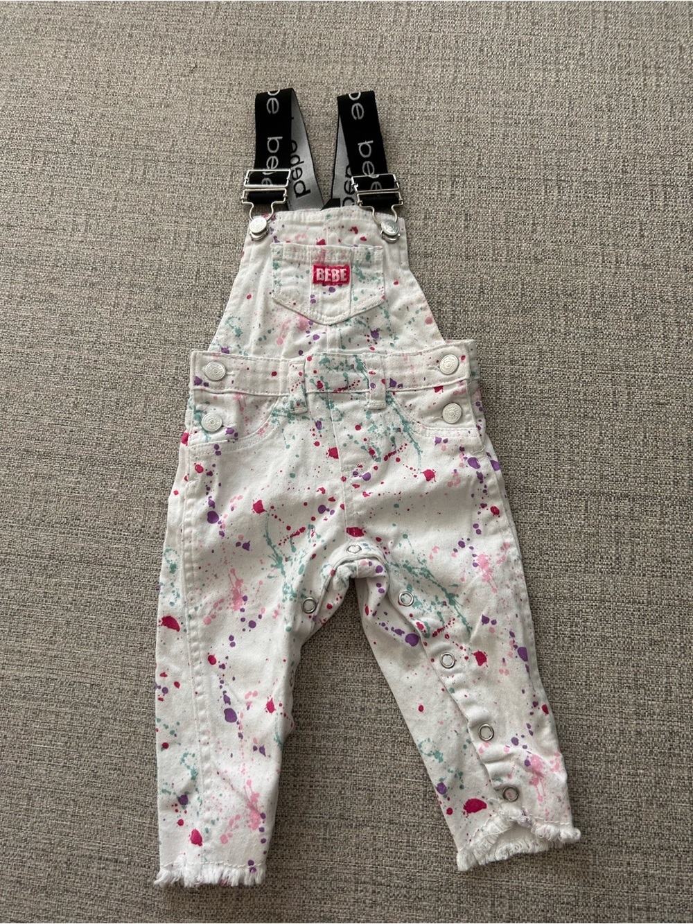 bebe White Paint-Splatter Overalls with Black Branded Straps. Size 12M